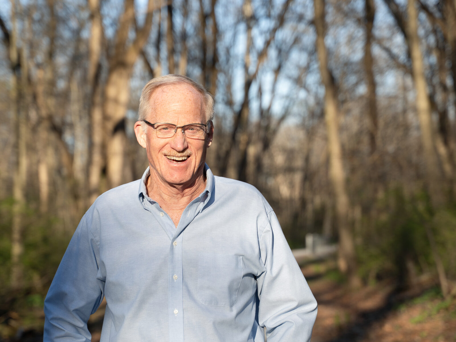 Hugh outdoors on a wooded trail